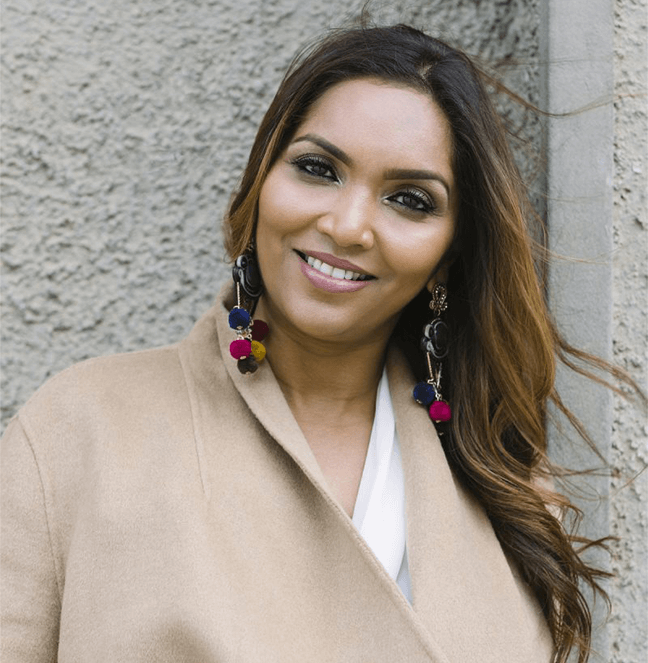 Woman posing in tan coat