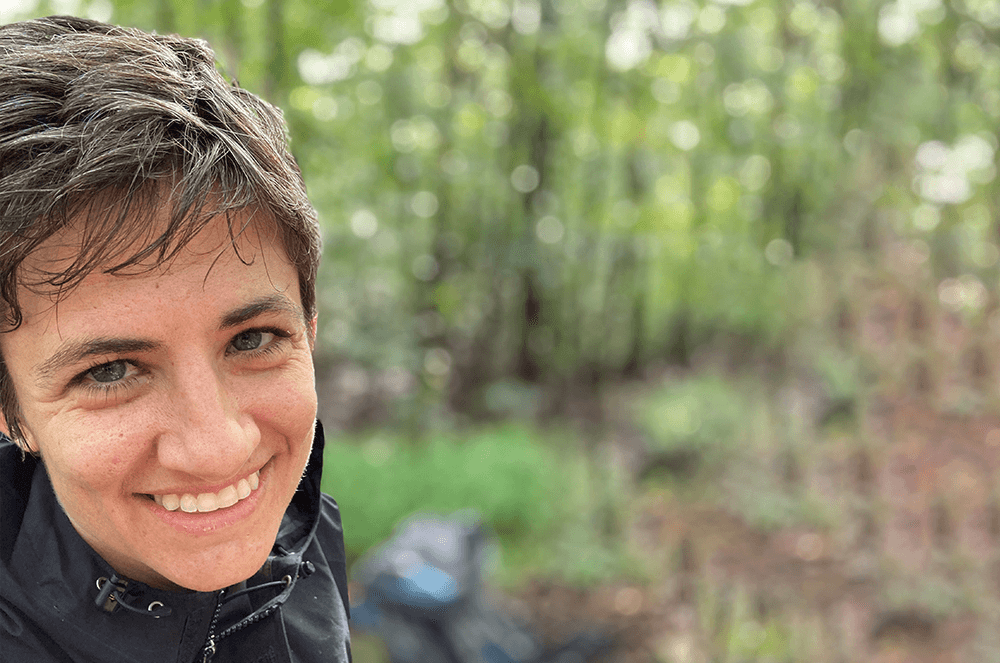 Woman smiling with trees in background