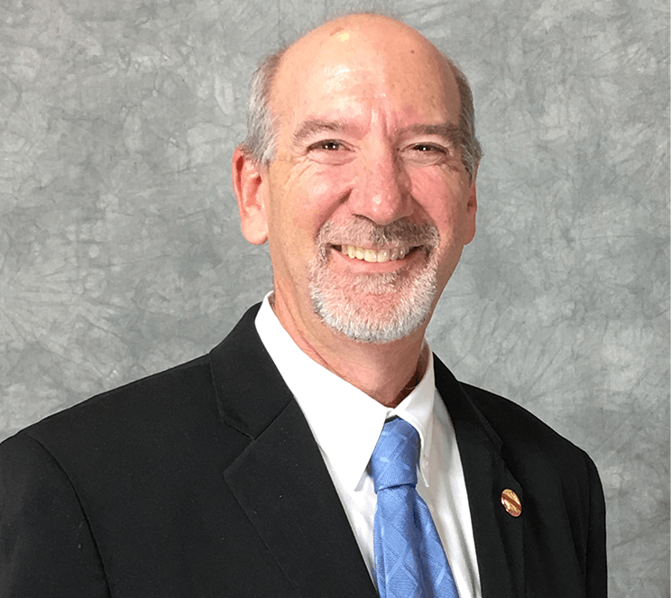 Man in suit and blue tie